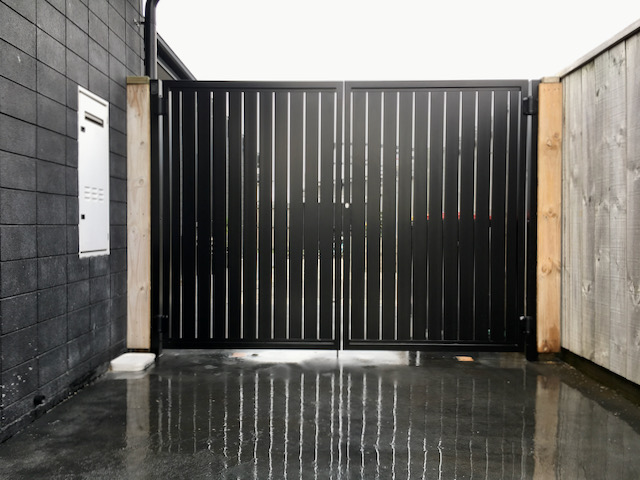 vertical double swing gate in black vertical slats
